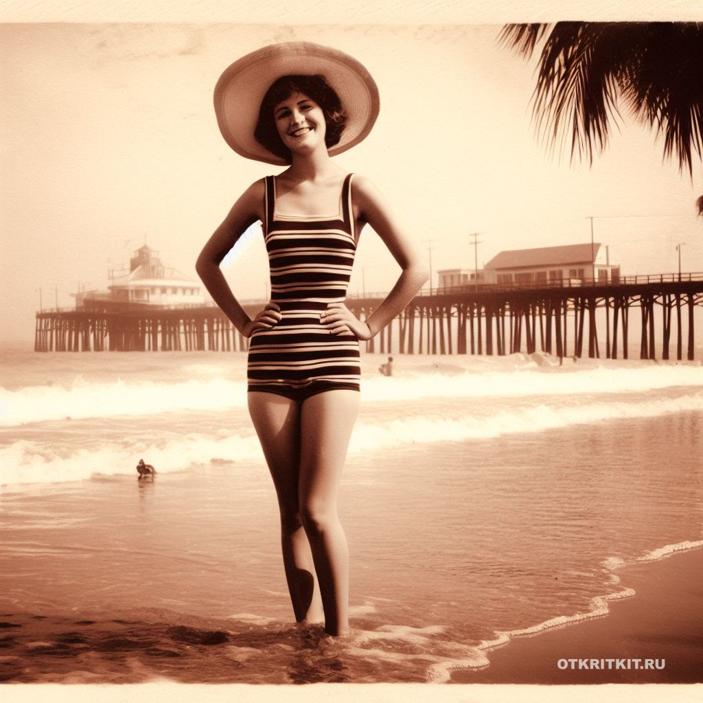 Девушка в купальнике стоит на песочном пляже